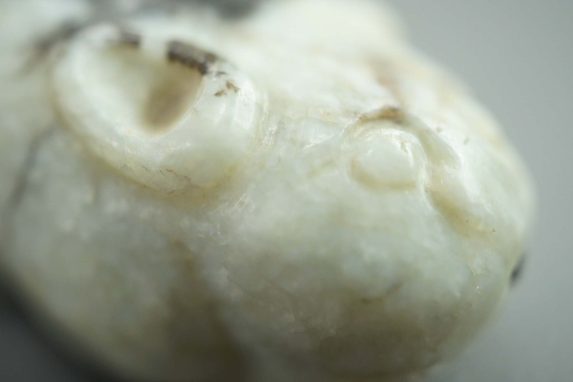 A Chinese white and black jade figure of a recumbent tiger, Song dynasty